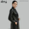 Close-up of leather texture, stitching, and side seam on women's double breasted coat