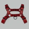 Full view of a genuine red leather harness for men displaying complete strap layout, metal hardware, and overall structure