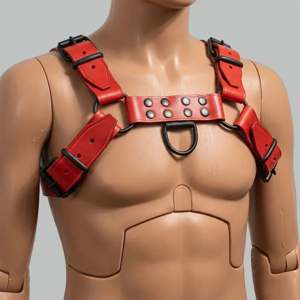 Red leather harness for men with adjustable chest and shoulder straps and metal buckle hardware