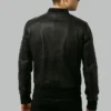 Back view of black leather bomber jacket showing ribbed hem and shoulder seams
