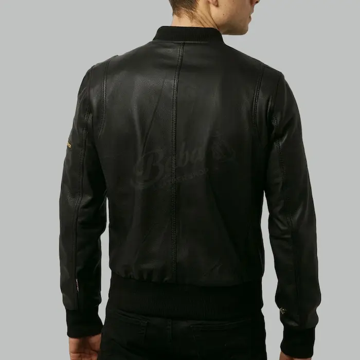 Back view of black leather bomber jacket showing ribbed hem and shoulder seams