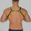 Back view of leather body harness showing strap crossover and adjustment buckles