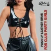 Model wearing a glossy black leather lace up top with front cross-lacing