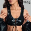Detailed close-up of a high-gloss black lace up leather top showing eyelet lacing.