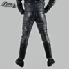 Back view of mens black quilted leather pants with diamond-stitched seat panels, worn with engineer boots